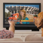 Idaho Potato Farmer in blue hat with dog sitting on couch watching TV of EvansHardy+Young Commercial