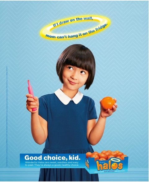 Halo ad featuring girl with halo over her head holding fruit 