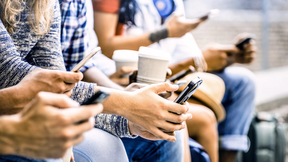 Millennials sitting with coffee looking at phone for Social Media Marketing