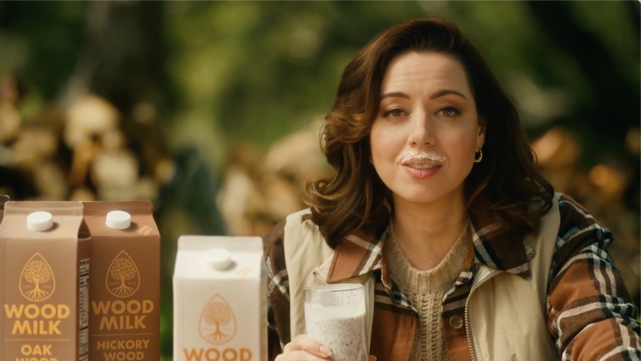 Woman drinking wood pulp milk in a satire ad