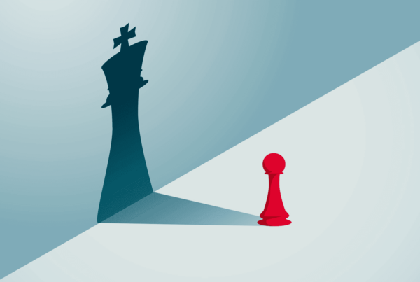 A red pawn and a chess piece on a blue background, representing strategy in food and branded produce marketing.