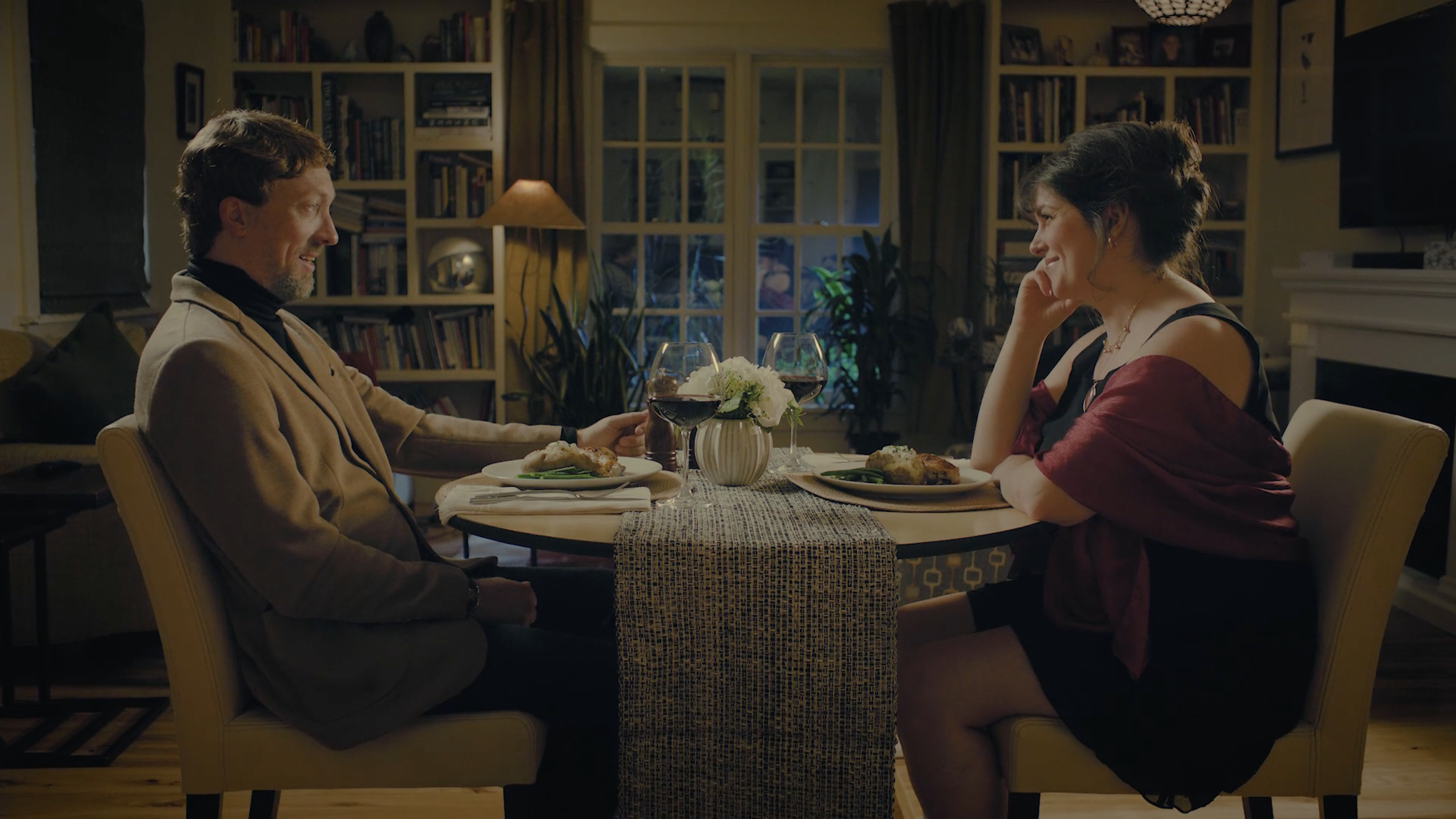 A man and woman discuss marketing strategies for CPG and branded products at a table in an agency office.